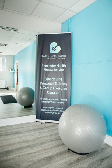 An image of a exercise gym ball and a pop up banner advertising personal training.